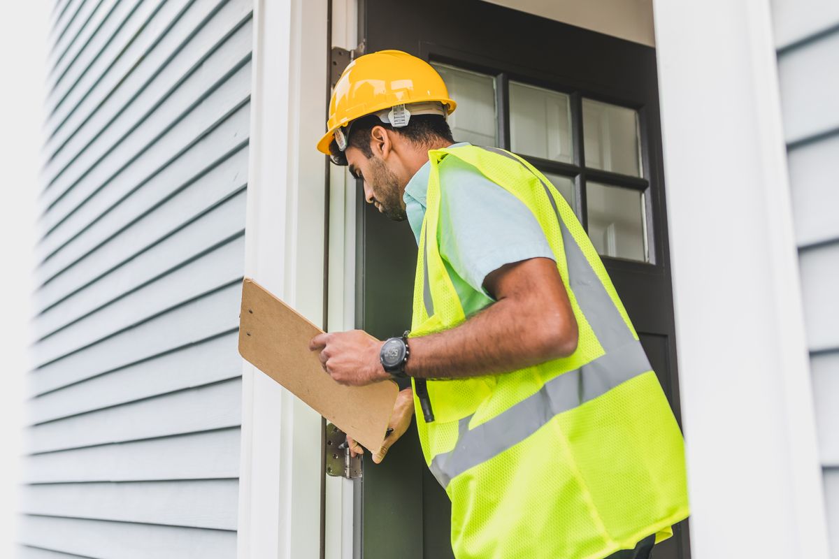 Inspector checking the exterior of a home